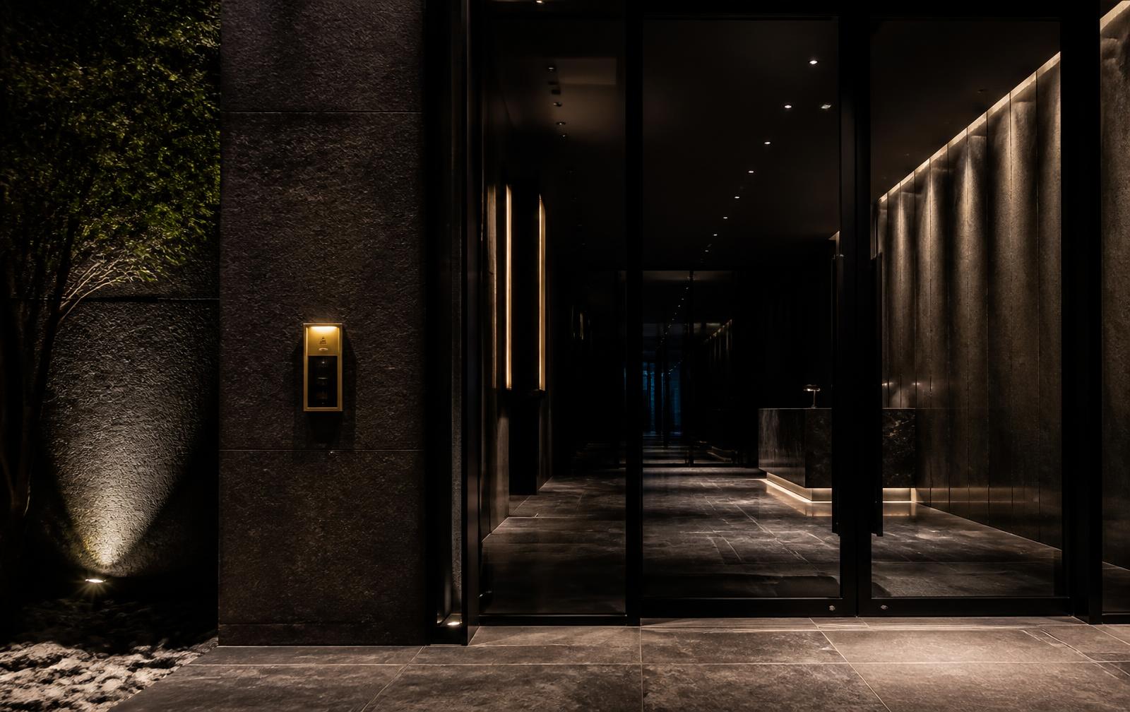 Secure lobby entrance with access control reader lit in warm gold light